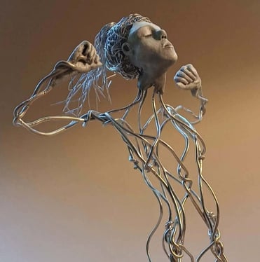 A wire sculpture of a complete kneeling female figure with clay hands, face and feet, arms raised