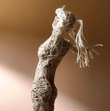 A cotton-covered wire sculpture of a standing female figure stretching with arms raised