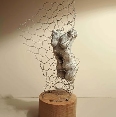 A clay female torso surrounded by wire netting, painted in neutral colours