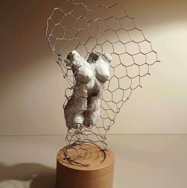 A clay female torso surrounded by wire netting, painted in neutral colours