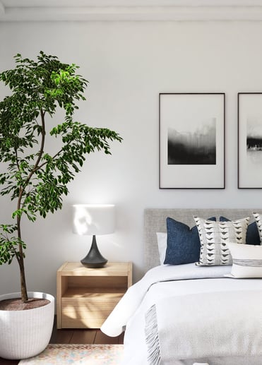 un dormitorio con una cama, una jardinera y una maceta
