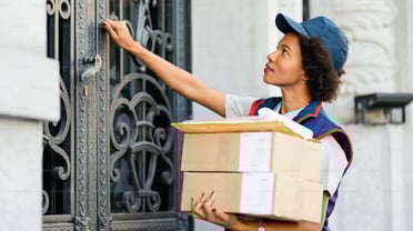 a woman in a blue uniform is holding a box with a box of boxes