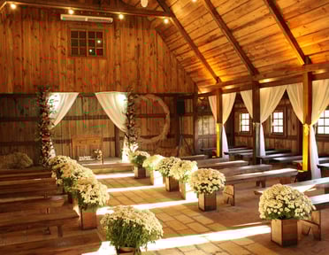 a barn decorated in off whites for a wedding
