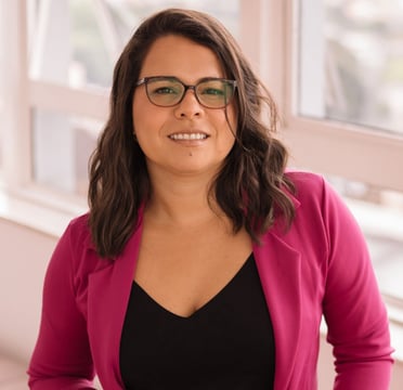a woman therapist in her office in front of a window