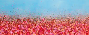 a field of red flowers with a blue sky in the background