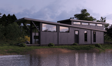 Modern prefab modular tiny home by the water at dusk