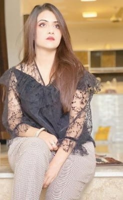 GFE escort Sana smiling softly at a café in Gurugram