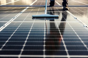 a person cleaning a solar paneled floor