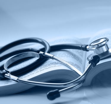 An open medical book with a stethoscope on top of it