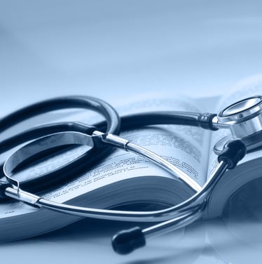 An open medical book with a stethoscope on top of it