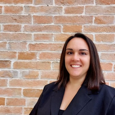 Italian language tutor, smiling warmly in a professional setting. Passionate about