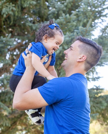 a man holding a baby in his arms