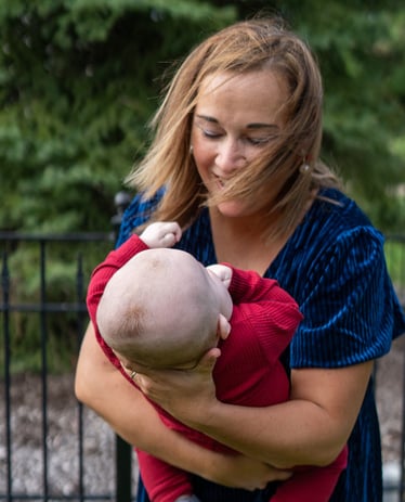 a woman holding a baby in her arms