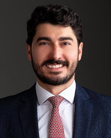 a lawyer in a suit and tie smiling