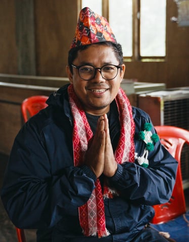 nepali man in traditional costume smiling
