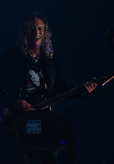 Kirk Hammett with a guitar and a microphone