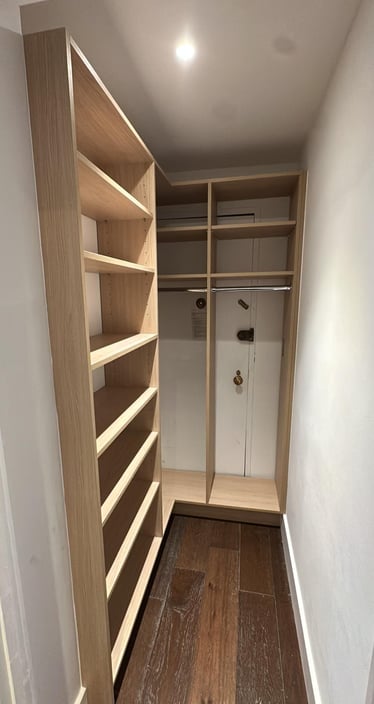a closet with a closet door open and a closet with shelves