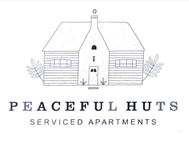 Peacefulhuts serviced apartments logo