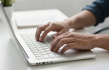 Hands typing on a minimalist keyboard in a bright, clean office environment, focused on productivity and professional growth, Global / English-speaking context.