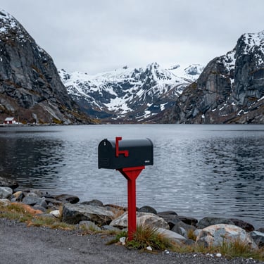 A cozy campervan parked by a serene fjord at sunset in Senja.