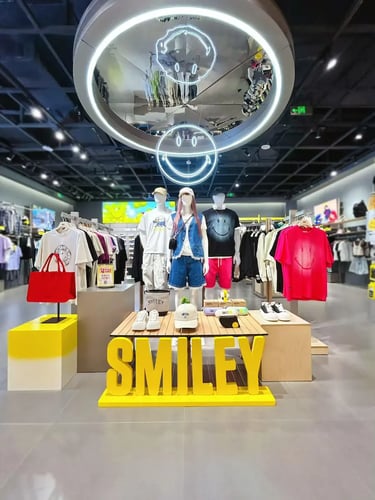 Mannequins wearing casual Smiley face apparel in a modern streetwear clothing store display.