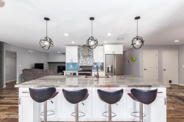 Custom kitchen renovation with large island and pendant lighting near me