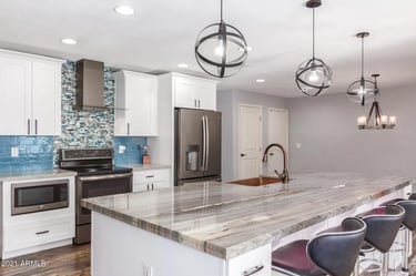 Modern kitchen remodel with white shaker cabinets and quartz countertops in Greensboro NC