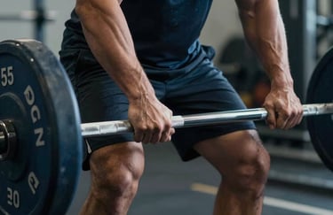 A macro photograph of an athlete's hands gripping a barbell, showing focus and determination. Lighting is dramatic but clean, with colors in Dark Slate and Steel Blue.