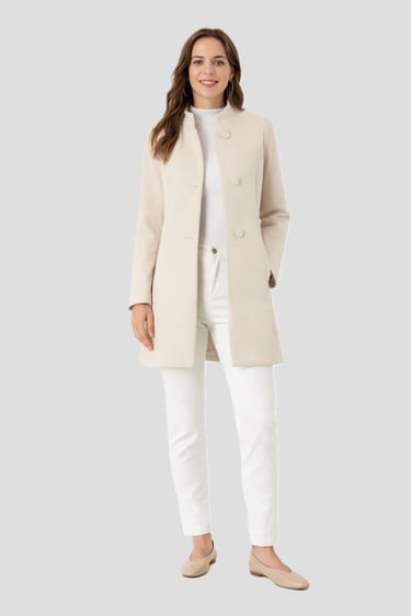 beige trench coat hanging — minimalist wardrobe outerwear essential