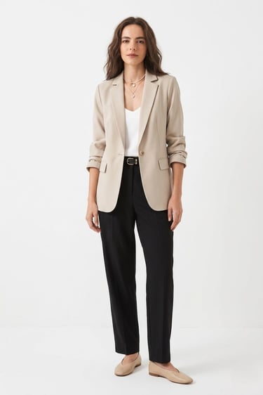 neutral blazer styled on model — a minimalist wardrobe layering essential