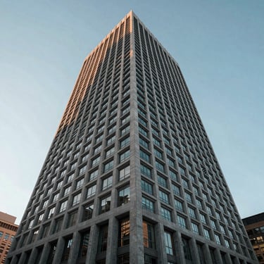 Low-angle photography of a modern architectural building in a major North American city, clear sky, representing stability and global presence.