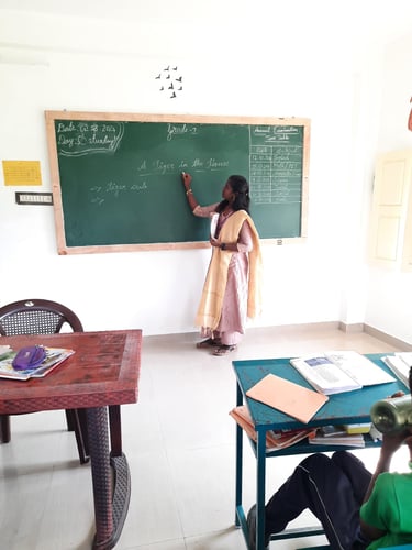 Teacher providing personalized tuition for primary school children at Little Cubs Learning Academy