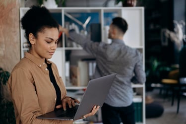 Woman looking at a CE course on her laptop with a man behind her.