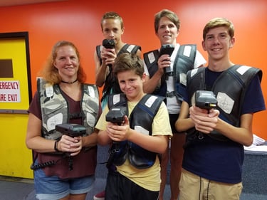 family posing for laser tag