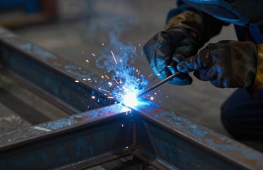 A close-up of precise welding on a steel structure, vibrant blue arc light illuminating the dark metal, showcasing expert technique and reliability, brand colors #2C272E used for steel surfaces.