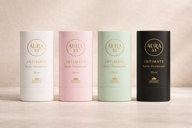 Aura 33 organic intimate balm deodorant tubes in white, pink, mint, and black packaging.