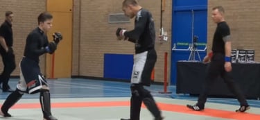 Sports massage therapist TJay Harvey competing in a dynamic combat sports tournament.