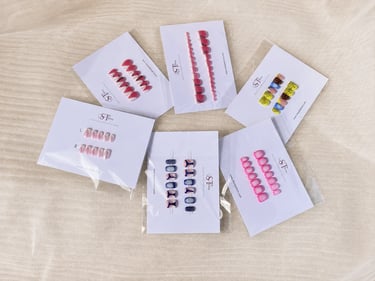 Six packs of SharpTalons press-on nails arranged in a circle, showing watermelon, animal print, abst