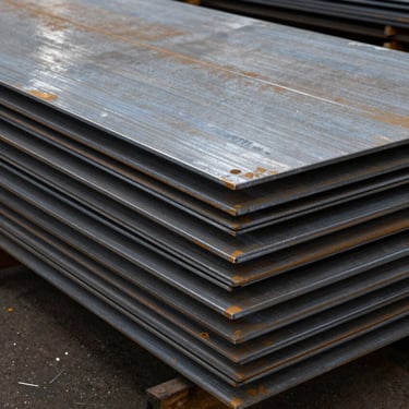 Detailed photography of thick steel plates stacked in a South American industrial facility, clean surfaces, dramatic side lighting highlighting the steel texture.