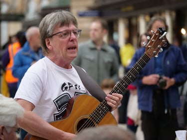 Finlay Allison with guitar in Glasgow central station