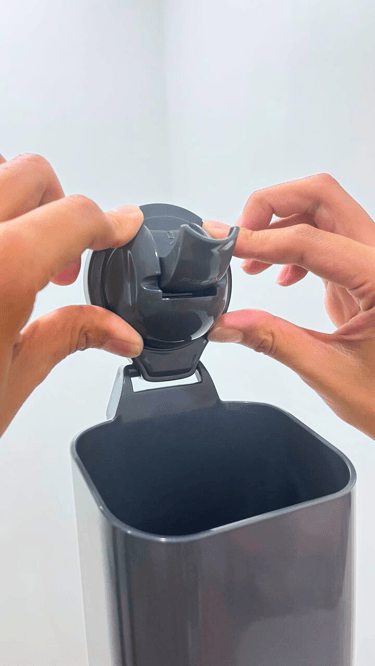 Hands pressing a suction cup hook to make inside vacuum.