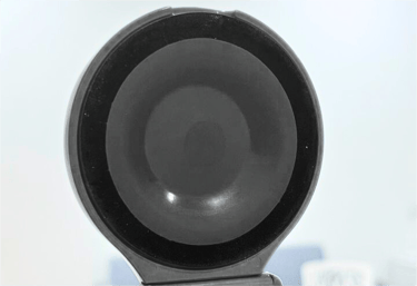 Back view of a suction cup attached to a surface.