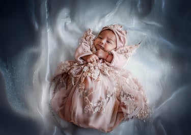 Neonata in abito rosa fotografata da Gaudife a Bologna – fotografia newborn emozionale con luce naturale e stile raffinato
