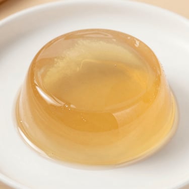 A colorful variety of fruit gelatin molds and jelly snacks arranged on parchment paper.