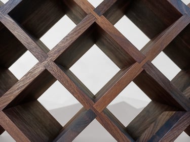 Close-up of geometric wine rack cells showing beautiful texture and exact joinery in American walnut