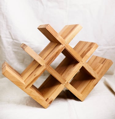 Standard 8-bottle oak wine rack photographed on light textile background in studio setting