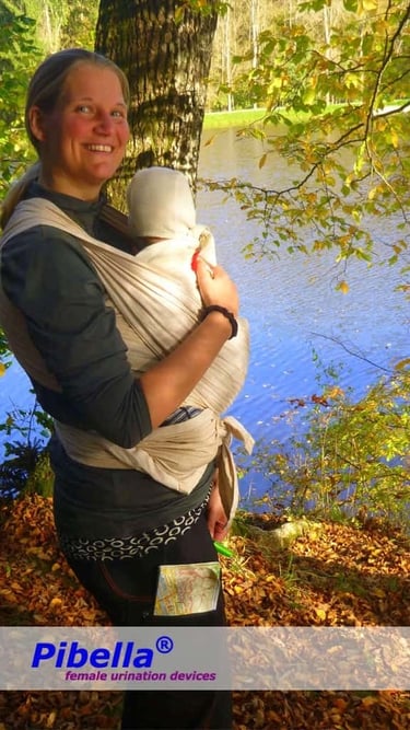 Mother carrying baby while using Pibella Travel
