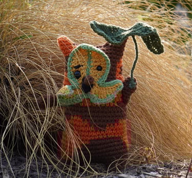 A korok holding a leaf standing in a bush.