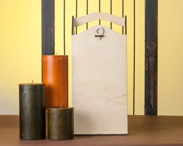 Village Engravers custom Gift Box for liquor shown with tall candles, gate and yellow background. #Product Photography, #Det