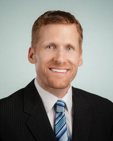 Male Executive in dark suit on light greenish background. #Business Photography, #Corporate Portrait Photography